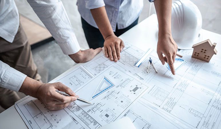 Engineers and architects drafting plans